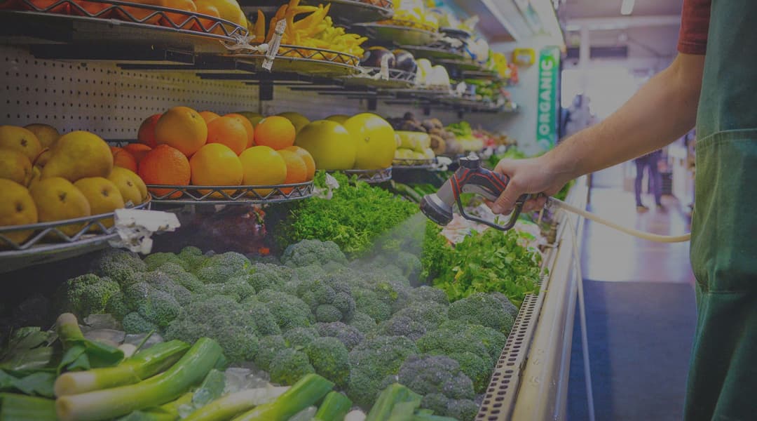 Fresh produce being misted in a wellness kitchen